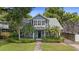 Charming light-blue two-story home with inviting front porch and lush landscaping at 530 S Eola Dr, Orlando, FL 32801
