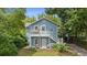 Charming blue two-story home with a double porch surrounded by lush greenery at 530 S Eola Dr, Orlando, FL 32801