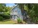 Charming blue two-story home with a double porch surrounded by mature trees at 530 S Eola Dr, Orlando, FL 32801