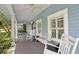 Relaxing front porch with rocking chairs, bench, and ceiling fans for comfortable outdoor living at 530 S Eola Dr, Orlando, FL 32801