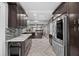 Well-designed kitchen with dark wood cabinets, marble counters, and stainless steel fridge at 530 S Eola Dr, Orlando, FL 32801