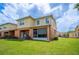 Two-story home with a well-maintained lawn and a screened-in patio for outdoor enjoyment at 4034 Winding Vine Dr, Lakeland, FL 33812
