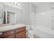 Bright bathroom with a vanity, mirror, toilet, and shower-tub combination at 4034 Winding Vine Dr, Lakeland, FL 33812