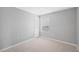 Neutral bedroom with plush carpeting, white trim, one window and an access door at 4034 Winding Vine Dr, Lakeland, FL 33812