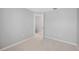 Neutral bedroom featuring plush carpeting, white trim, and an access door at 4034 Winding Vine Dr, Lakeland, FL 33812