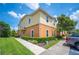 Two-story home featuring a well-kept lawn, mature landscaping, and a two-tone exterior paint scheme at 4034 Winding Vine Dr, Lakeland, FL 33812