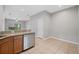 Kitchen with stainless steel appliances, granite countertops, and natural wood cabinets overlooking the living area at 4034 Winding Vine Dr, Lakeland, FL 33812