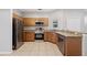 Bright kitchen with stainless steel appliances, granite countertops, and natural wood cabinets at 4034 Winding Vine Dr, Lakeland, FL 33812