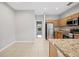 Bright kitchen featuring stainless steel appliances, granite countertops, and natural wood cabinets at 4034 Winding Vine Dr, Lakeland, FL 33812