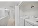 Convenient upstairs laundry room with shelving and full-size washer and dryer for easy chore completion at 4034 Winding Vine Dr, Lakeland, FL 33812