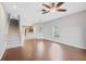 Open-concept living room with wood-look flooring, ceiling fan, and staircase to the upper level at 4034 Winding Vine Dr, Lakeland, FL 33812