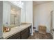 Bathroom featuring a vanity with countertop, a framed mirror, and a shower with glass doors at 4710 Osprey Way, Winter Haven, FL 33881