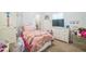 Cozy bedroom featuring a plush bed, dresser, and decorated with colorful ' accessories at 4710 Osprey Way, Winter Haven, FL 33881