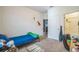 Neutral bedroom with carpet floors, featuring a twin bed, and access to a bathroom and an additional room at 4710 Osprey Way, Winter Haven, FL 33881