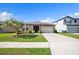 Attractive single-story house with a neatly maintained lawn, a two car garage, and an inviting screened porch at 4710 Osprey Way, Winter Haven, FL 33881