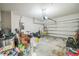 The garage features storage, a fan, tools, bikes, and a garage door with an electric opener at 4710 Osprey Way, Winter Haven, FL 33881