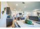 Open-concept kitchen featuring dark wood cabinets, stainless steel appliances, and a view of the living area at 4710 Osprey Way, Winter Haven, FL 33881