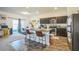 Open-concept kitchen featuring a granite island, stainless steel appliances, and dark wood cabinets at 4710 Osprey Way, Winter Haven, FL 33881