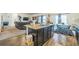 Open-concept kitchen with granite island, stainless steel dishwasher, and seamlessly connected to the living area at 4710 Osprey Way, Winter Haven, FL 33881
