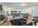 Spacious living room featuring dark leather furniture, modern decor, and seamless access to the kitchen at 4710 Osprey Way, Winter Haven, FL 33881