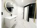 Bathroom with modern single vanity, a black marble walled-in tub, and luxurious gold finishes at 132 Canary Island Cir, Davenport, FL 33837