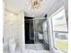 Bathroom with modern fixtures, marble-style tiling, and glass-enclosed shower at 132 Canary Island Cir, Davenport, FL 33837