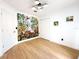 Bedroom with stylish nature-themed wallpaper, and wood floors at 132 Canary Island Cir, Davenport, FL 33837