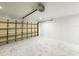 Clean, well-lit garage with epoxy flooring and white painted block walls at 132 Canary Island Cir, Davenport, FL 33837