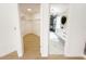 Hallway view to a large walk-in closet and a bathroom with modern fixtures at 132 Canary Island Cir, Davenport, FL 33837