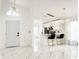 Modern open-concept kitchen with marble floors, sleek white cabinets, and stylish pendant lighting at 132 Canary Island Cir, Davenport, FL 33837