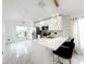 Bright modern kitchen with marble floors, white cabinets, quartz countertops, and stainless steel appliances at 132 Canary Island Cir, Davenport, FL 33837
