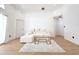 Bright living room with hardwood floors, white walls, a modern sofa, and a glass coffee table at 132 Canary Island Cir, Davenport, FL 33837