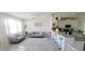Open living space with modern furniture and an eat-in kitchen with a breakfast bar at 1704 Felicity Ln, Kissimmee, FL 34744