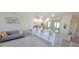 Open concept living area and kitchen boasts granite countertops and modern white cabinetry at 1704 Felicity Ln, Kissimmee, FL 34744