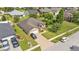An aerial shot of a single-story home showcasing the brick driveway, well-manicured lawn, and surrounding neighborhood at 311 Bentley Oaks Blvd, Auburndale, FL 33823