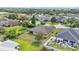 Aerial view showcasing the home's backyard, featuring a fenced-in yard with a patio and outdoor seating area at 311 Bentley Oaks Blvd, Auburndale, FL 33823