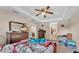 Spacious bedroom featuring a ceiling fan, tray ceiling, and ample natural light at 311 Bentley Oaks Blvd, Auburndale, FL 33823