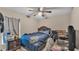 Relaxing bedroom with a ceiling fan, dresser, and study desk at 311 Bentley Oaks Blvd, Auburndale, FL 33823