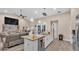 Bright kitchen with granite countertops, stainless steel appliances, and an island overlooking the living area at 311 Bentley Oaks Blvd, Auburndale, FL 33823