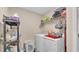 Functional laundry room with storage shelves and modern appliances at 311 Bentley Oaks Blvd, Auburndale, FL 33823