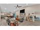 Bright open-concept living space with wood floors, a ceiling fan, and a large entertainment center at 311 Bentley Oaks Blvd, Auburndale, FL 33823