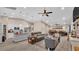 Bright, open-concept living space with wood floors, ceiling fan, and modern furnishings at 311 Bentley Oaks Blvd, Auburndale, FL 33823