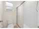 Bathroom featuring a sliding glass door shower, toilet, and a window providing natural light at 1760 Mountclair Ct, Mount Dora, FL 32757