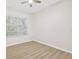 Bright bedroom with wood-look flooring and a large window with natural light at 1760 Mountclair Ct, Mount Dora, FL 32757