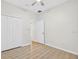 Bedroom featuring wood-look flooring, a ceiling fan, a closet, and a white paneled door at 1760 Mountclair Ct, Mount Dora, FL 32757