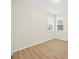 Bedroom with wood-look flooring, two windows with blinds, and neutral-colored walls at 1760 Mountclair Ct, Mount Dora, FL 32757