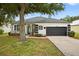 Charming single-story home featuring a two-car garage, landscaped front yard, and inviting entryway at 1760 Mountclair Ct, Mount Dora, FL 32757