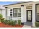 Inviting covered porch with white railings, decorative columns, and a glass-paneled front door at 1760 Mountclair Ct, Mount Dora, FL 32757