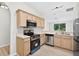 Bright kitchen with stainless steel appliances, light wood cabinetry, and plenty of counter space at 1760 Mountclair Ct, Mount Dora, FL 32757