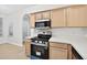 Bright kitchen features stainless steel appliances, light wood cabinets and white countertops at 1760 Mountclair Ct, Mount Dora, FL 32757